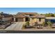 Exterior elevation of a single-story home with a tile roof, three-car garage, and desert landscaping at 5252 W Posse Dr, Eloy, AZ 85131