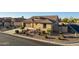 Aerial view of a single-story home with a two-car garage, desert landscaping, and palm trees at 5252 W Posse Dr, Eloy, AZ 85131