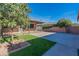 Backyard with brick patio, grass and mature trees at 705 W Vernon Ave, Phoenix, AZ 85007