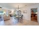 Bright dining area with glass-top table and four chairs, adjacent to living room at 8260 E Keats Ave # 508, Mesa, AZ 85209