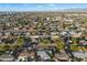 An aerial view of houses in a neighborhood with trees and mountains at 8307 E Weldon Ave, Scottsdale, AZ 85251