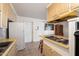 Kitchen with electric range, double sink, and door to exterior at 8307 E Weldon Ave, Scottsdale, AZ 85251