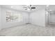 Bright living room with tile flooring, white walls, and a ceiling fan at 8824 W Cheery Lynn Rd, Phoenix, AZ 85037