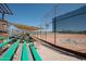 Baseball field with bleachers, covered spectator area, and safety netting at 8865 E Baseline Rd # 1129, Mesa, AZ 85209