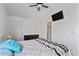Bedroom with mounted TV, ceiling fan, and access to laundry at 8865 E Baseline Rd # 1129, Mesa, AZ 85209
