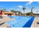 Community pool with lounge chairs, umbrellas, and a nearby clubhouse at 8865 E Baseline Rd # 1129, Mesa, AZ 85209