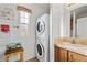 Stackable washer and dryer in a laundry room with wood cabinets at 8865 E Baseline Rd # 1129, Mesa, AZ 85209