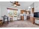 Open concept living room with kitchen view, ceiling fan, and carpeted floor at 8865 E Baseline Rd # 1129, Mesa, AZ 85209