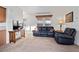 Living room with leather furniture, ceiling fan, and carpeted floor at 8865 E Baseline Rd # 1129, Mesa, AZ 85209