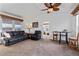 Spacious living room with leather furniture, ceiling fan, and carpeted floor at 8865 E Baseline Rd # 1129, Mesa, AZ 85209