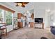 Open concept living room with kitchen view, ceiling fan, and carpeted floor at 8865 E Baseline Rd # 1129, Mesa, AZ 85209