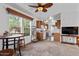 Open concept living room with kitchen view, ceiling fan, and carpeted floor at 8865 E Baseline Rd # 1129, Mesa, AZ 85209