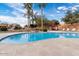 Relaxing community pool with waterfall feature and lounge chairs at 8865 E Baseline Rd # 1129, Mesa, AZ 85209