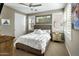 Bedroom with white bedding, ceiling fan, plantation shutters, and carpeted floors at 9001 E San Victor Dr # 2024, Scottsdale, AZ 85258