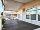 Covered front porch with wood-look decking, white railing, and a parked golf cart at 9333 E University Dr # Ofc, Mesa, AZ 85207