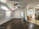 Living room with wood-look flooring, ceiling fan, and view into the kitchen at 9333 E University Dr # Ofc, Mesa, AZ 85207