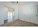 Bedroom with carpeted floors, white closet doors, and view to another room at 993 S Lawson Dr, Apache Junction, AZ 85120