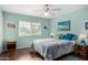 Cozy bedroom with wood-look flooring, ceiling fan, and large window with blinds at 10202 W Mountain View Rd, Sun City, AZ 85351