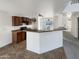 Kitchen with brown cabinets, breakfast bar, and tile flooring at 11214 W Rio Vista Ln, Avondale, AZ 85323