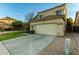 Attractive two-story home with a tiled roof, attached garage, and landscaped front yard at 12905 W Soledad St, El Mirage, AZ 85335