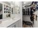 Bathroom with a double vanity sink, large mirror, and walk-in closet at 14002 N 125Th Dr, El Mirage, AZ 85335