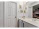 The bathroom includes a single sink vanity, white cabinetry, and decorative accents at 14002 N 125Th Dr, El Mirage, AZ 85335