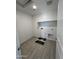 Bright laundry room with ample shelving and modern flooring at 17535 W Lupine Ave, Goodyear, AZ 85338