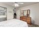 Guest bedroom with a queen-size bed, dresser, and mirrored closet doors at 220 N 22Nd Pl # 1108, Mesa, AZ 85213