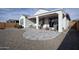 Private backyard with a covered patio, pavers, and desert landscaping at 27421 W Pontiac Dr, Buckeye, AZ 85396