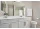 Bathroom vanity with white cabinets, mirror, and toilet at 2928 S Washington St, Chandler, AZ 85286