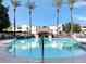 Community pool with palm trees, lounge chairs, and a covered area at 3302 N 7Th St # 226, Phoenix, AZ 85014