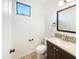 Clean bathroom with dark wood vanity, white countertop, and mosaic tile backsplash at 3636 E Stampede Dr, Gilbert, AZ 85297