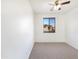 Bedroom with carpet flooring, ceiling fan, and large window at 3636 E Stampede Dr, Gilbert, AZ 85297