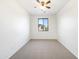 Bedroom with carpet flooring, ceiling fan, and large window at 3636 E Stampede Dr, Gilbert, AZ 85297