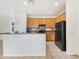 Kitchen with wood cabinets, black appliances, and a decorative backsplash at 3636 E Stampede Dr, Gilbert, AZ 85297