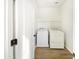 Laundry room with washer, dryer, and built-in shelving at 3636 E Stampede Dr, Gilbert, AZ 85297