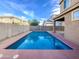 Inviting backyard pool with surrounding patio and block wall fencing at 3636 E Stampede Dr, Gilbert, AZ 85297