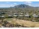 Community nestled beside a lush green golf course with mountain views at 36601 N Mule Train Rd # B14, Carefree, AZ 85377