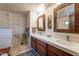 Modern bathroom featuring dual sinks, walk-in shower, and decorative tile work at 36601 N Mule Train Rd # B14, Carefree, AZ 85377