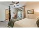 Bedroom with four-poster bed, ceiling fan, and access to a private patio at 36601 N Mule Train Rd # B14, Carefree, AZ 85377