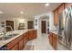 View of the kitchen's granite island, stainless steel appliances, and wood cabinetry at 36601 N Mule Train Rd # B14, Carefree, AZ 85377