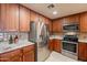 Modern kitchen featuring stainless steel appliances, granite countertops, and rich wood cabinets at 36601 N Mule Train Rd # B14, Carefree, AZ 85377