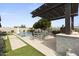 Covered patio with built-in grill, pool, and artificial turf at 36959 N Camarillo Dr, San Tan Valley, AZ 85140