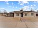 Front exterior view of single-story home with a walkway leading to the entrance at 461 N Madison St, Wickenburg, AZ 85390