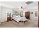 Bright main bedroom with a large bed, wood armoire, and window shutters at 4660 E Torrey Pines Lane Ln, Chandler, AZ 85249