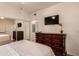 Spacious bedroom with a dresser, TV and ensuite bathroom access at 7009 E Acoma Dr # 1135, Scottsdale, AZ 85254