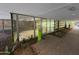 Building entrance with glass doors, intercom, and lush landscaping at 7151 E Rancho Vista Dr # 4001, Scottsdale, AZ 85251