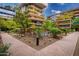 Community pool area with lounge chairs, lush landscaping, and modern architecture at 7151 E Rancho Vista Dr # 4001, Scottsdale, AZ 85251