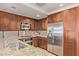 Spacious kitchen featuring stainless steel appliances, ample wood cabinetry, and granite countertops at 7151 E Rancho Vista Dr # 4001, Scottsdale, AZ 85251
