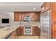 Kitchen with stainless steel appliances, wood cabinetry, and granite countertops at 7151 E Rancho Vista Dr # 4001, Scottsdale, AZ 85251